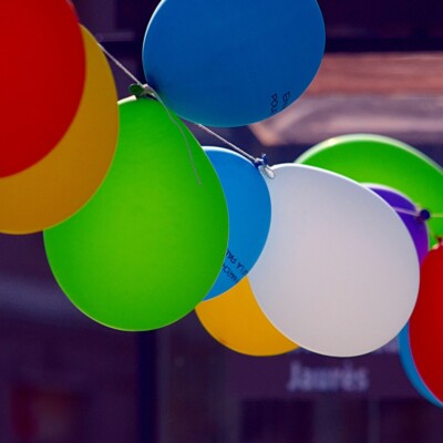 Des ballons colorés suspendus, symbolisant la fête et la convivialité dans la commune de Feuguerolles-Bully.