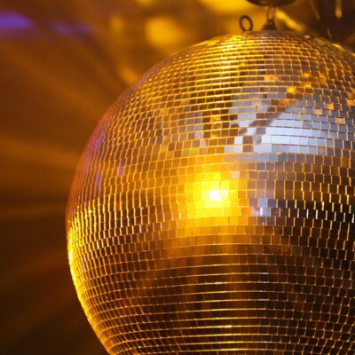 Disco ball reflecting light in a colorful setting, creating a festive atmosphere.